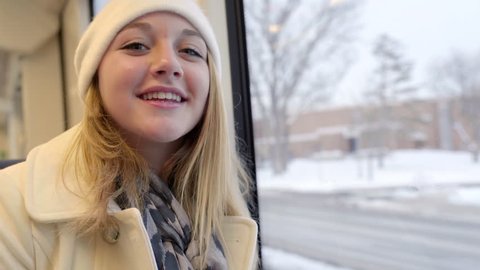 Closeup Of Happy Teenager Traveling On A Train In Winter, She Smiles Wide  库存视频