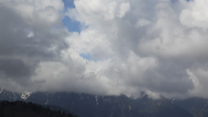 Stormy clouds above mountain peaks,time lapse