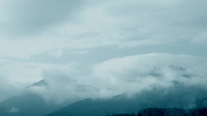 Morning fog across mountain peaks,time lapse