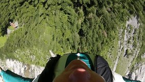 Base jumper jumping of a cliff as an extreme sport.  Sky diving and parachuting daredevils B.A.S.E jump from great heights.