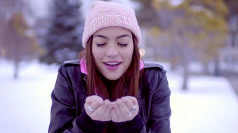 Beautiful Multi-Ethnic Teen Blows Handful Of Snow At Camera And Smiles (Slow Motion)