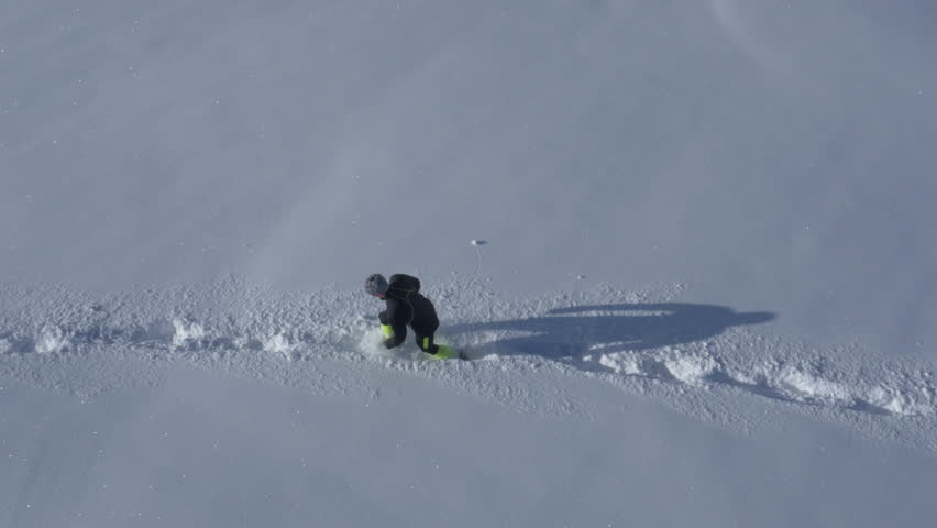 Aerial - Man in sportswear walking in a field of snow