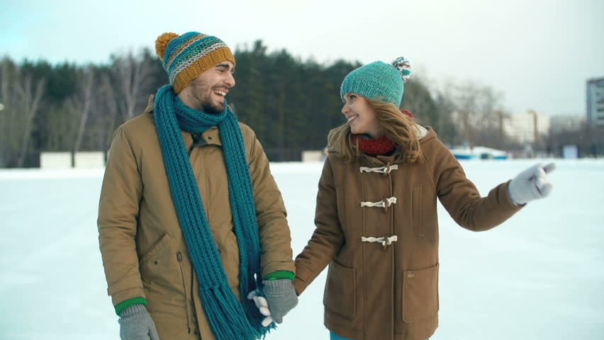 Slow motion of couple approaching camera skating 