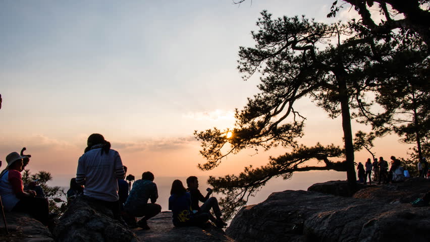 Traveler take a photo sunset on the mountain wite time lapse