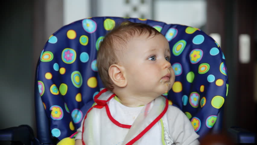 Joyful baby boy at lunch time