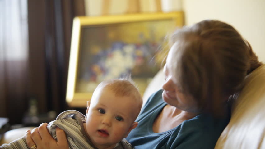 Baby boy and mother in living room