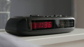 Tracking into digital alarm clock, late morning. - Powered by Shutterstock - Get 15% off with code: PIKWIZARD15
