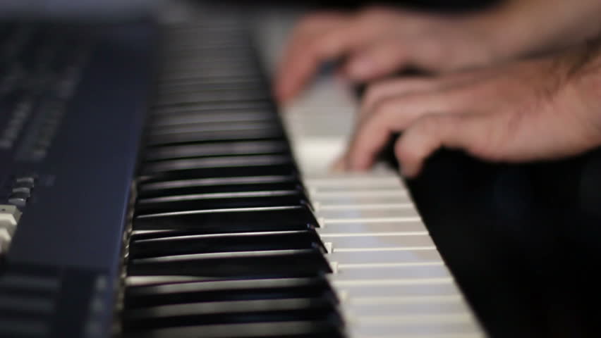 hands playing on keyboard