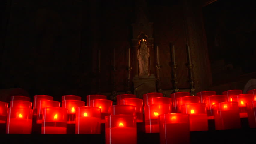 Prayer candles and icon representing the Virgin Mary