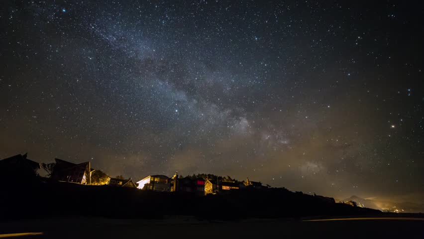 Time lapse of milky way above houses by the beach. Taken at Cannon Beach, Oregon