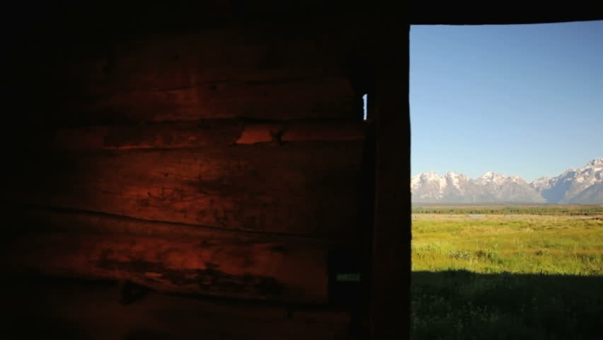 View of the Grand Tetons from inside the Cunningham Cabin, dolly shot