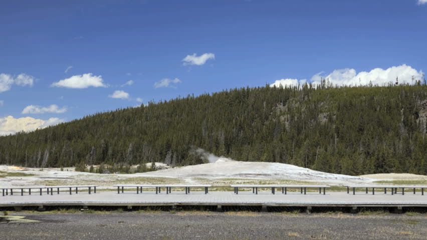Time lapse shot of visitors on the boardwalk watching Old Faithful geyser erupt in Yellowstone National Park