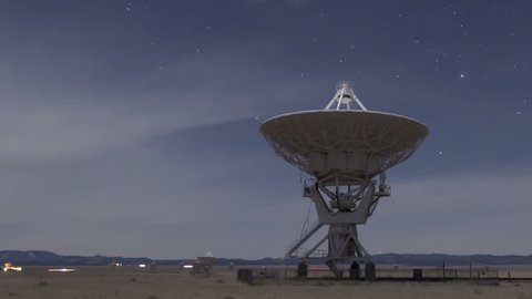 Time lapse Very Large Array Radio Telescopes dishes moving at night with stars in New Mexico, USA