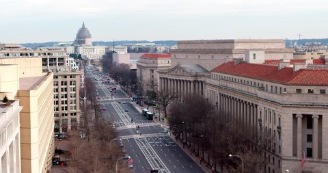 Super wide US Capitol and Pennsylvania Avenue Winter January 2015 scaffolded US Capitol dome with FBI Building on the left and The National Archives on the right. 