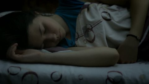 Girl sleeping in the bed late at night, restless