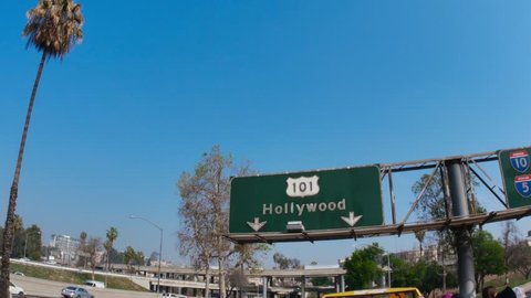 A unique perspective of driving under a Hollywood road sign on the 101.