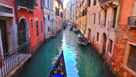 Romantic tour in gondola, rowed by a gondolier in the venice canal.