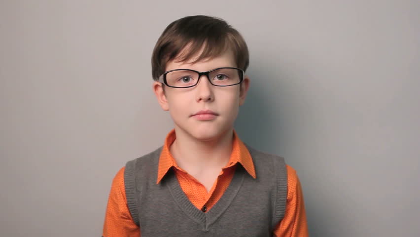 boy ten years old frightened on a gray background