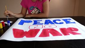 Woman Painting Peace No War on Paper with Gouache. HD, 1920x1080. - Powered by Shutterstock - Get 15% off with code: PIKWIZARD15