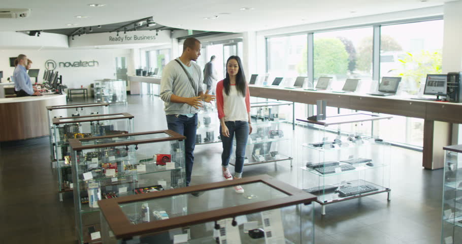 4K Couple shopping in consumer electronics store showroom