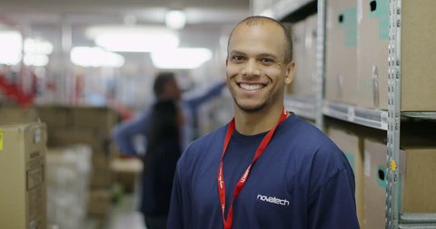 4K Portrait of cheerful male worker in a warehouse or factory 库存视频