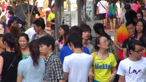SHENZHEN, CHINA - MAY 5, 2012, Timelapse of busy sidewalk with commuter people by day
