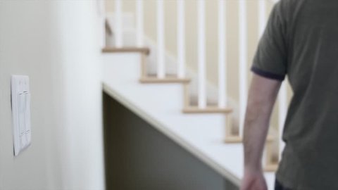 A man walking up and down the stairs in his home