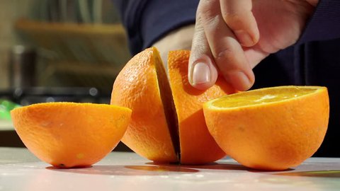 cutting fresh oranges to squeezing oranges and make orange juice
