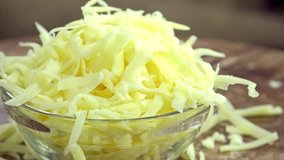 Portion of grated Cheese (not loopable 4K footage)