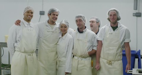 4K Portrait of cheerful team of workers in a seafood processing factory