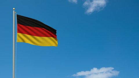 Flag of Germany waving in the wind in front of blue sky