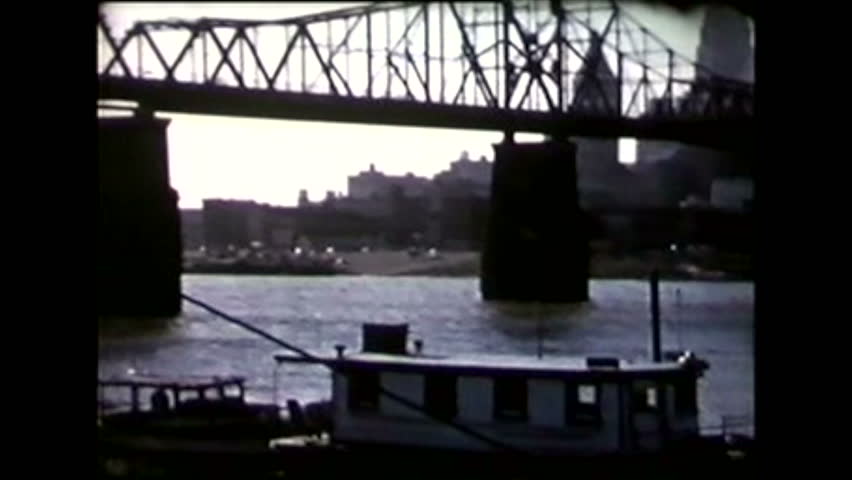 Pan over the Ohio river showing L&N and C&O bridges and the skyline of Cincinnati. 1950
