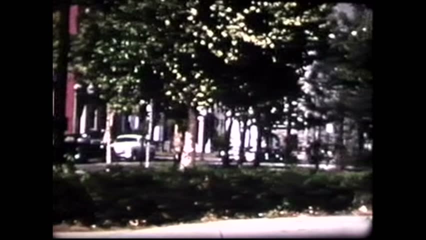 Square in Cincinnati in the summer, camera pan ends on statue of Abraham Lincoln, where kids are playing. USA, 1950