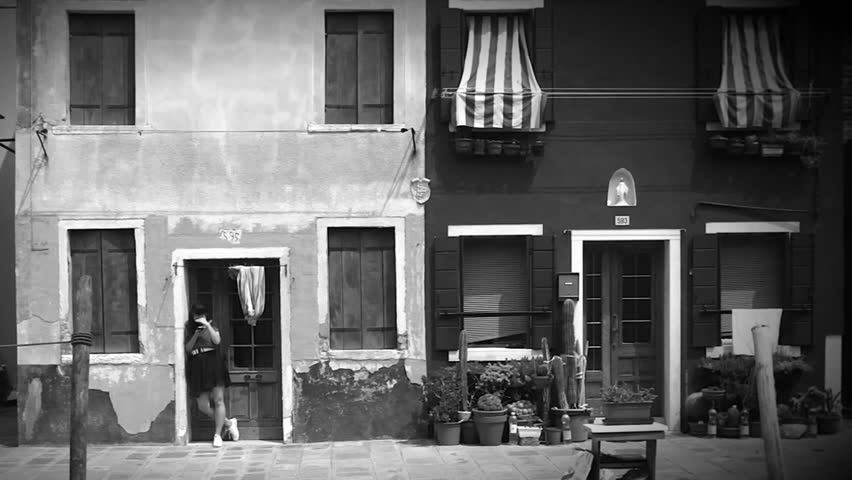  The girl standing on the doorway in old house of Burano ( black and white )