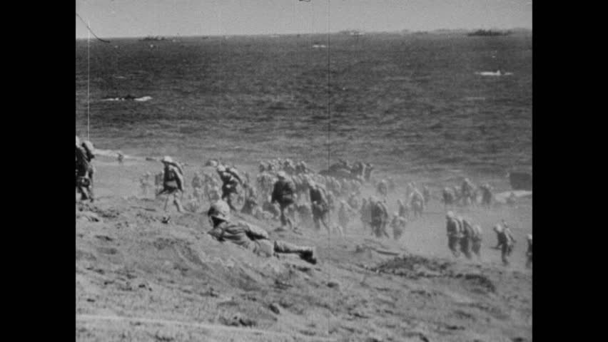 U.S. Marines arrive on beaches of Iwo Jima for Operation Detachment against Japanese Empire during World War II, Japan, circa February 1945