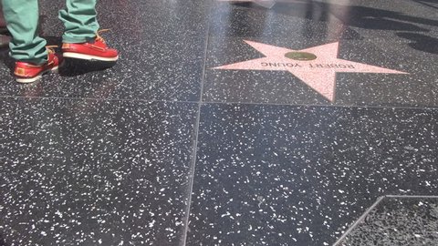 LOS ANGELES - USA, APRIL 2, 2013, POV Point of view of pedestrian people feet on walk of fame by day