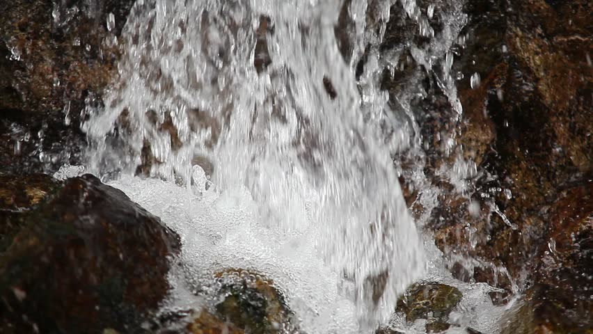 Water falling, small forest cascade close up