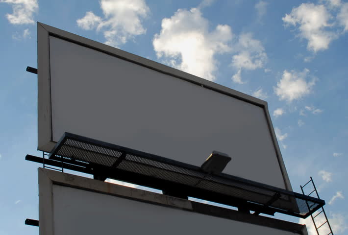 Blank billboard against clouds time lapse