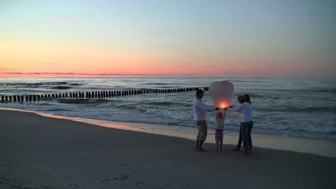  Family light sky lanterns on the beach  Stock Video