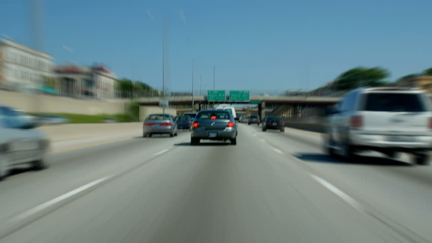 Daytime freeway driving into city with motion blur time lapse