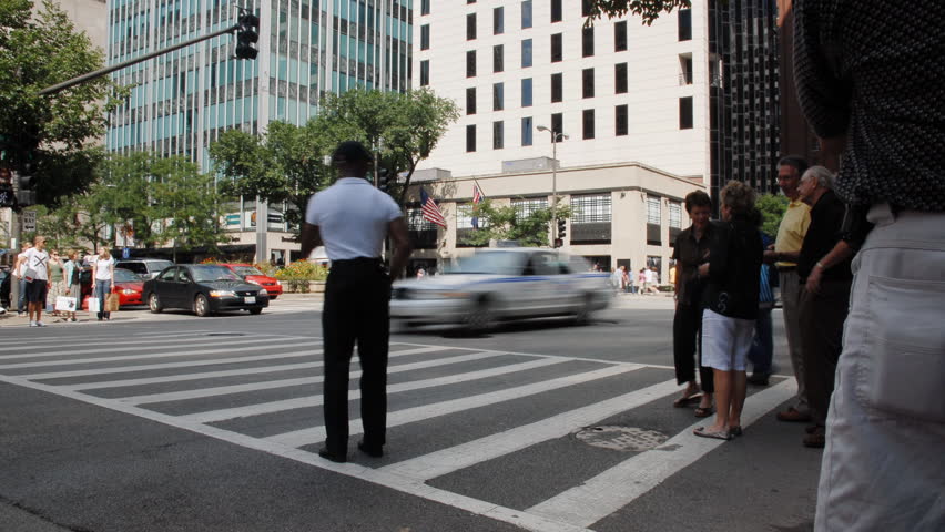 Crowds crossing urban street time lapse
