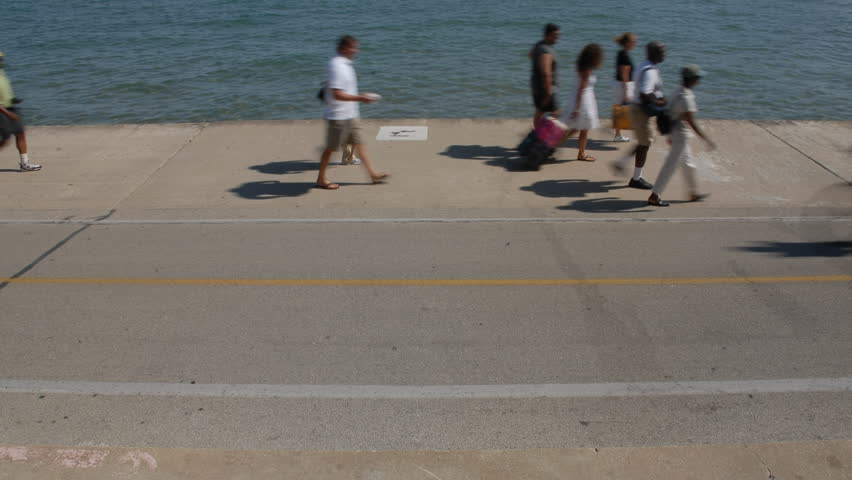 Daytime city waterfront walkway time lapse