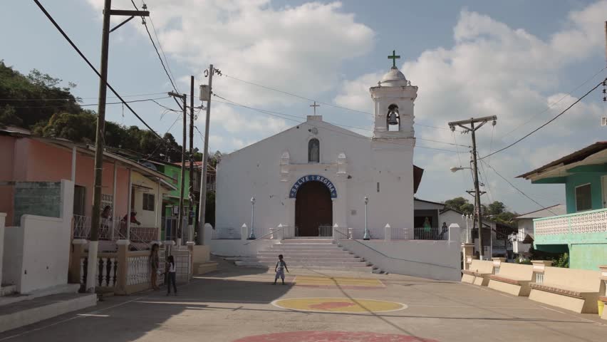 Panama City, Panama - February 15, 2015: Children playing in the main square of Isla Taboga near the Catholic Church