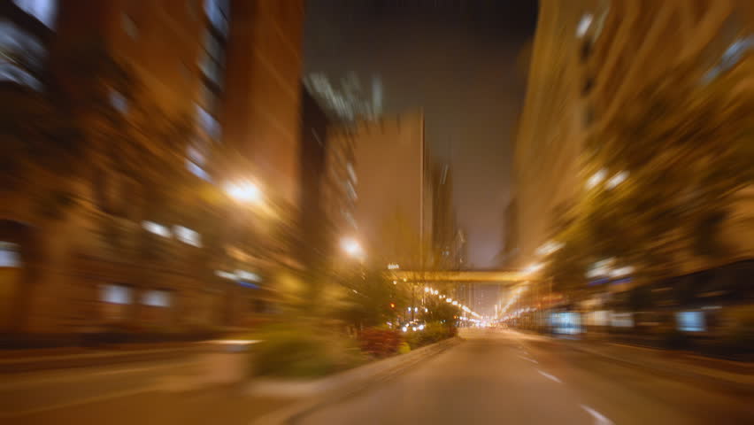 Driving through city streets at night time lapse