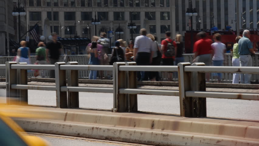 People and traffic crossing city bridge time lapse