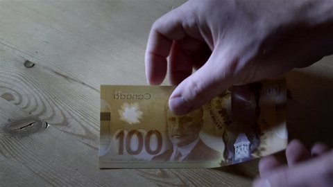 Counting $100 Canadian bills. Filmed in 4K UHD.
