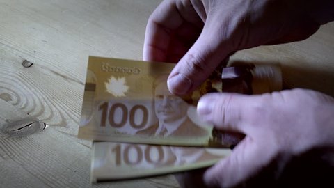 Counting $100 Canadian bills. Filmed in 4K UHD.