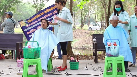 NAKHONSAWAN, THAILAND - FEBRUARY 21: unidentified people get haircut in outdoor barber in the park on February 21, 2015 in Nakhonsawan, Thailand.

