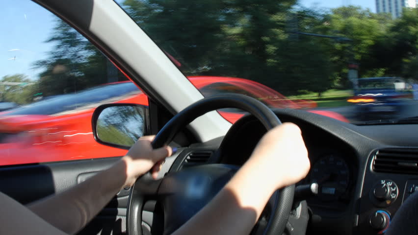 Steering car through city traffic time lapse