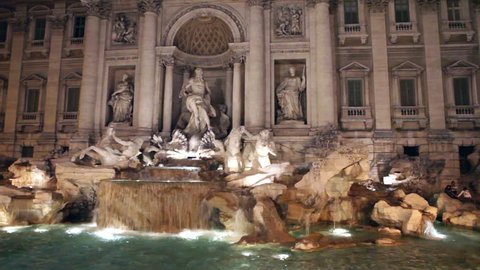 Trevi Fountain in Rome in night illumination, with flashfrom tourists photocameras 